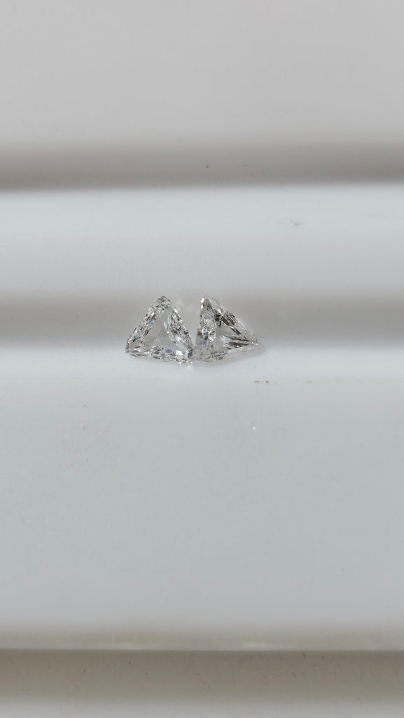 0.53 TCW 2 Natural step-cut Trilliants non-match chipped G-H SI